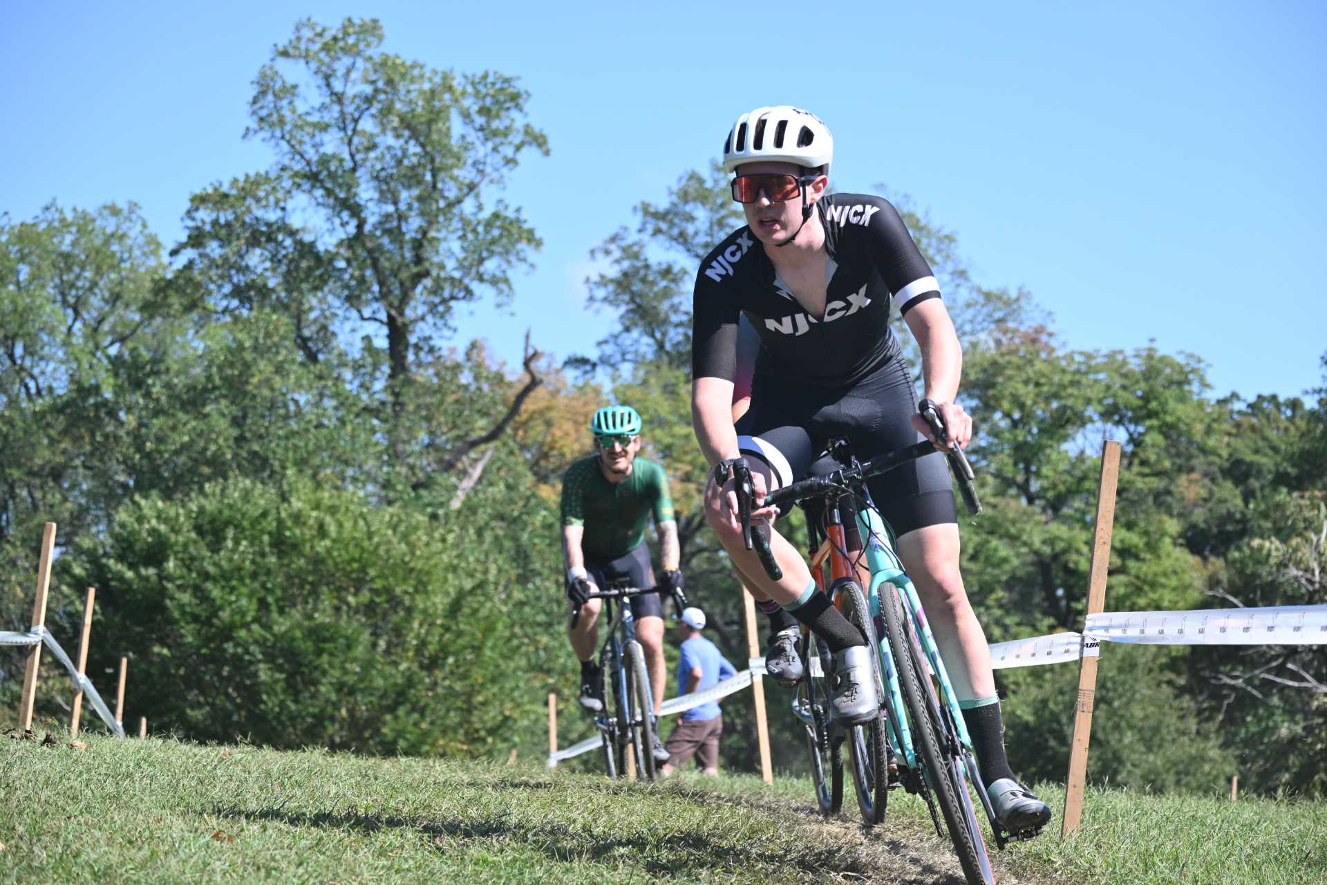 An NJCX rider grinds through deep mud and rain at a cyclocross race
